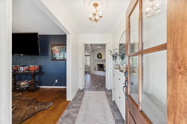 a hallway with kids room bathroom and bedroom with wooden floor