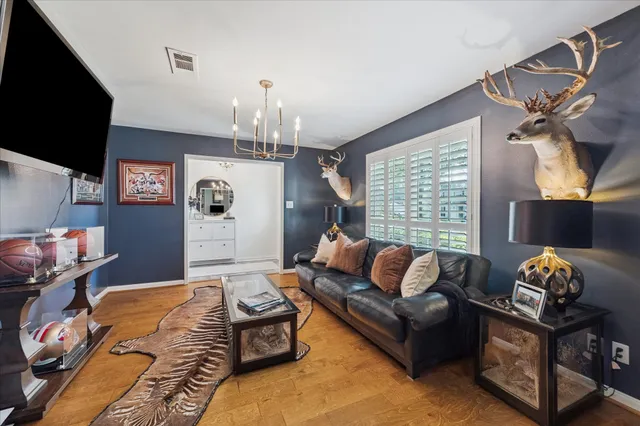 a bedroom with furniture and a flat screen tv