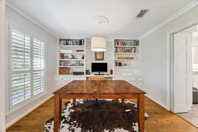 a room with pool table and windows