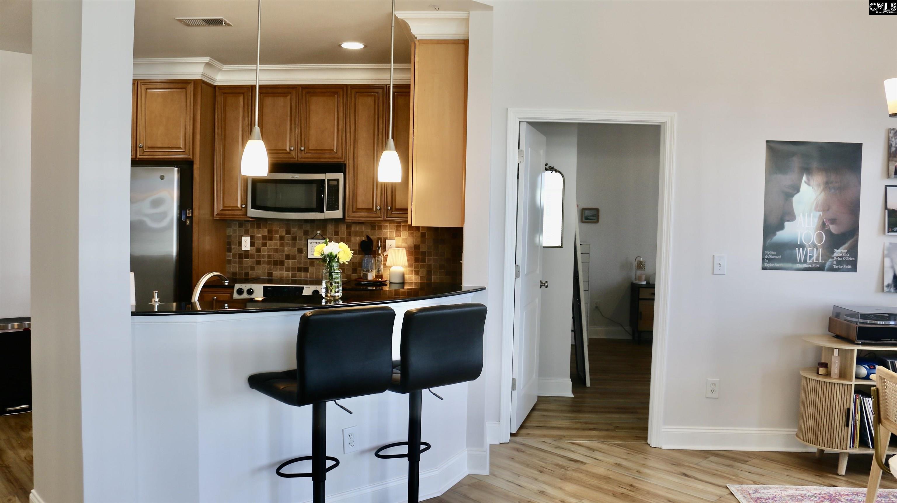 601 Main Street, Unit 323 Columbia, SC 29201 - Photo 5 of 68 a kitchen with granite countertop a sink cabinets and stainless steel appliances