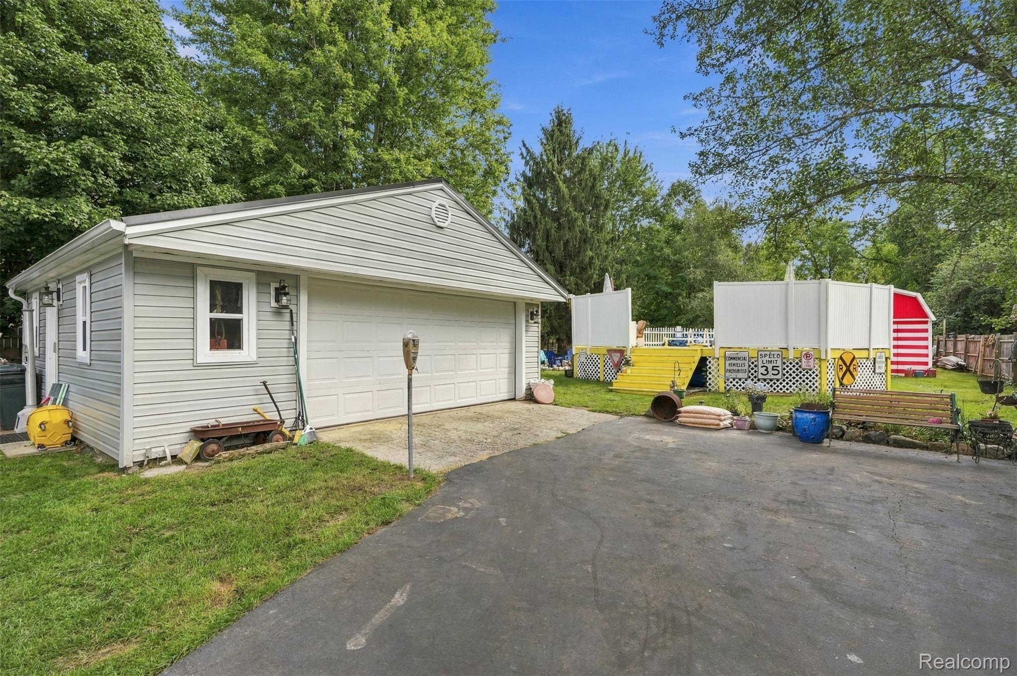 36739 Wick Road Romulus, MI 48174 - Photo 30 of 56 Detached garage with horizontal siding, a single garage door, and an exterior window