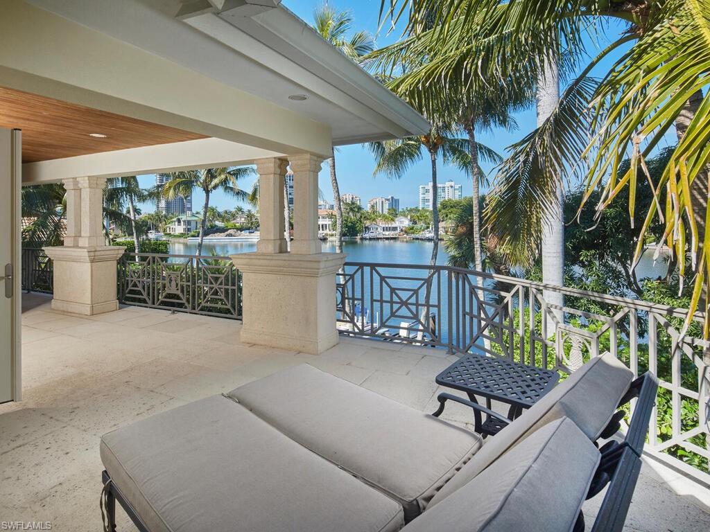 377 Pirates Bight Naples, FL 34103 - Photo 35 of 44 a balcony with furniture and potted plants