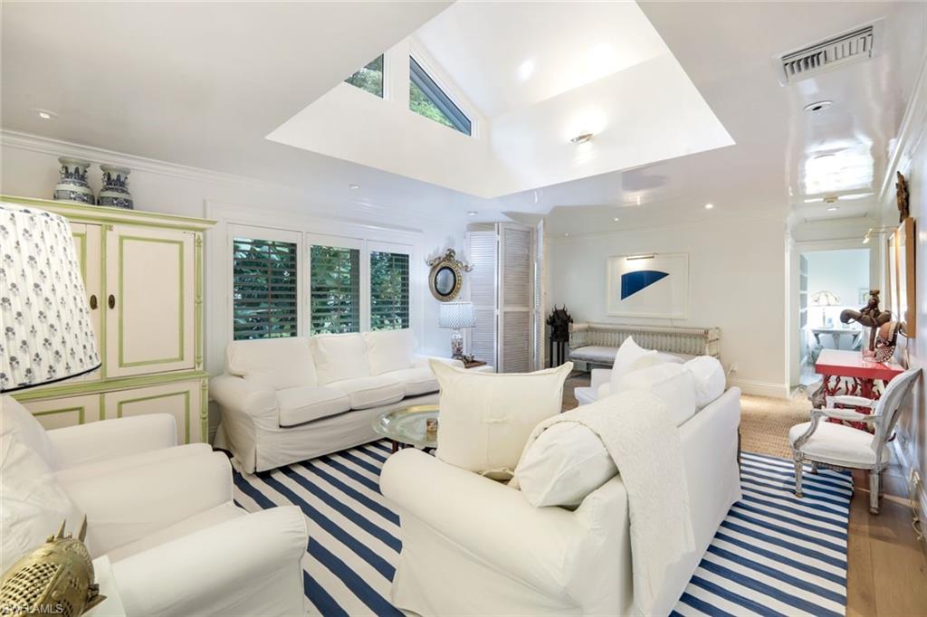 295 6th Street North Naples, FL 34102 - Photo 6 of 32 a living room with furniture and a large window