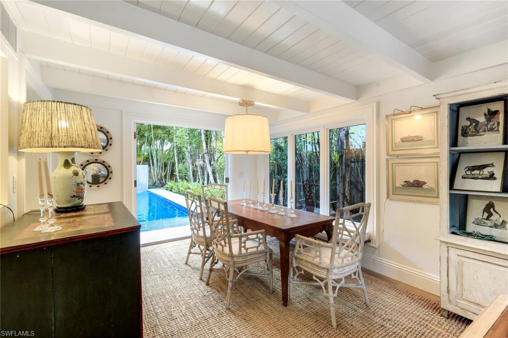 295 6th Street North Naples, FL 34102 - Photo 7 of 32 a view of a dining room with furniture window and outside view