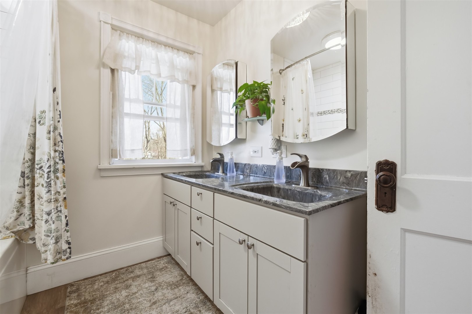 600 Normal Avenue Normal, IL 61761 - Photo 17 of 29 a bathroom with a granite countertop sink a mirror and a window
