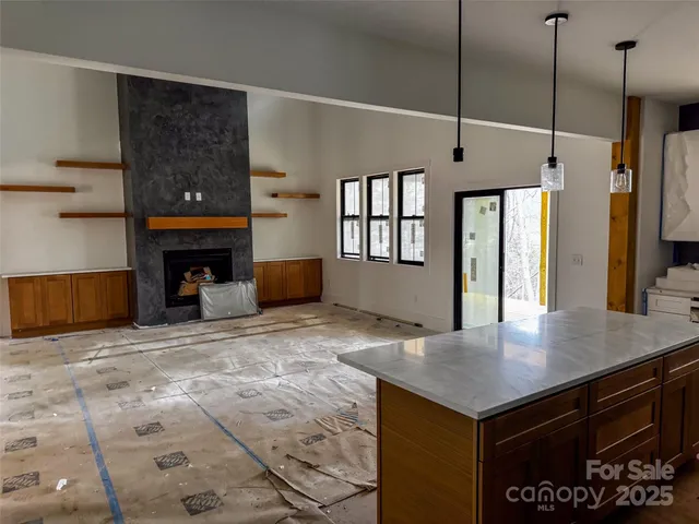 a kitchen with kitchen island a sink stainless steel appliances and a counter top space