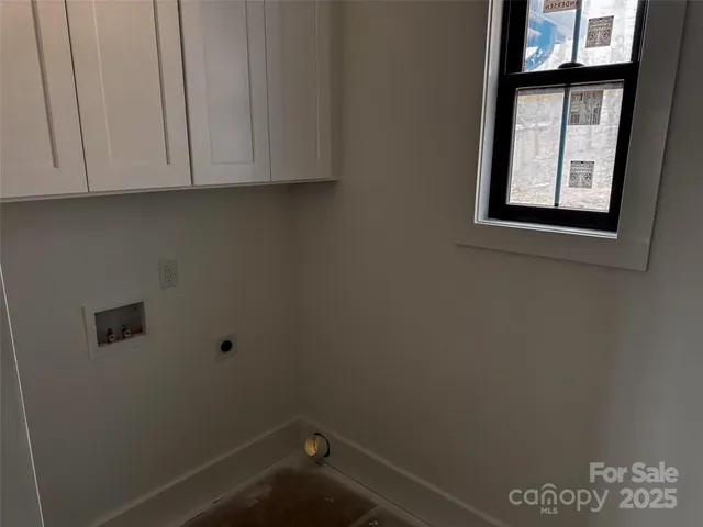 a view of storage and utility room with window