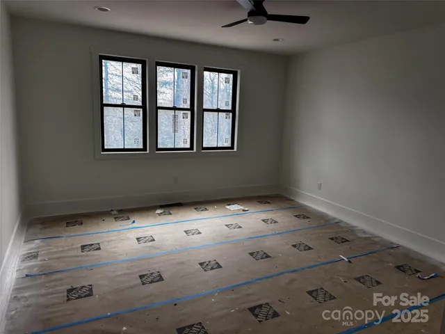 a view of room with baby crib and window