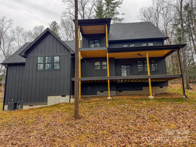a view of a house with a wooden fence
