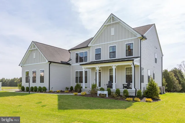 a front view of a house with a yard patio and swimming pool