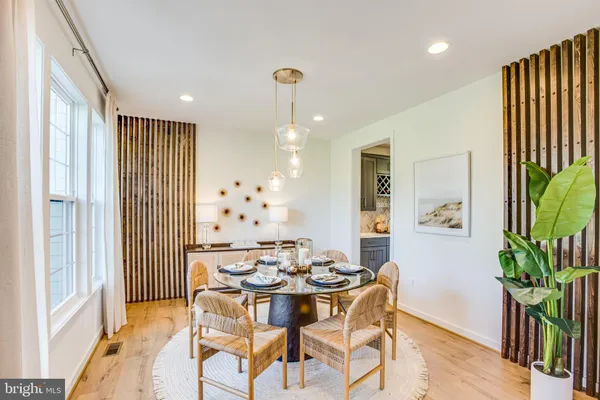 a kitchen with kitchen island a stove a table and chairs in it
