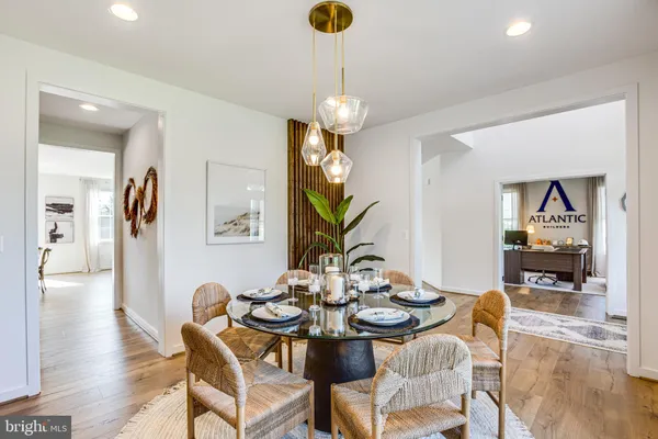 a kitchen with stainless steel appliances a sink a stove and a wooden floor
