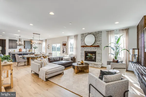 a living room with furniture a flat screen tv and a window