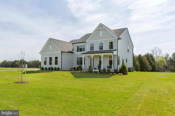 a front view of house with yard and trees