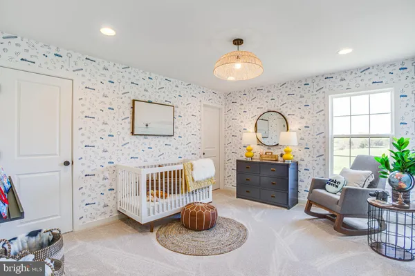a spacious bedroom with a bed a table and chair