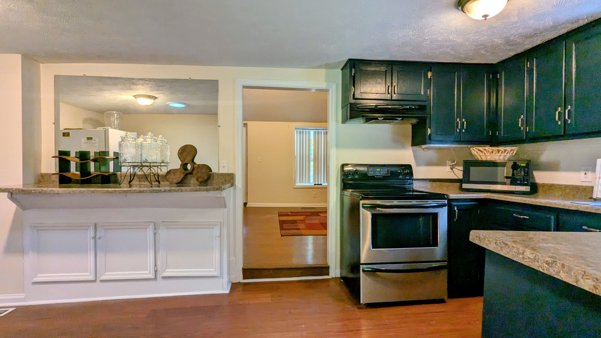 335 Turkey Creek Road Carthage, TN 37030 - Photo 16 of 36 a kitchen with stainless steel appliances granite countertop wooden cabinets a stove and a sink