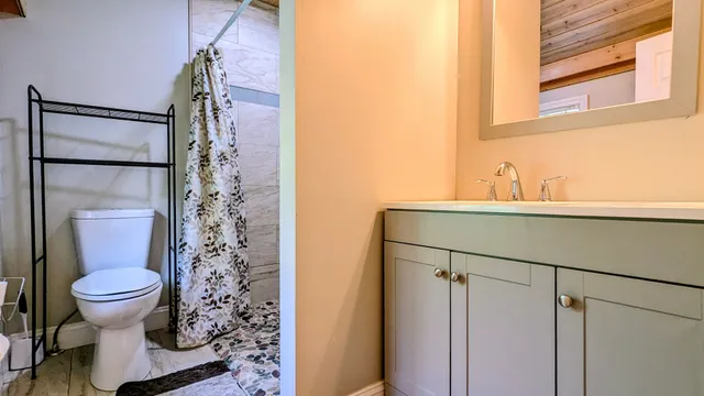 a bathroom with a sink toilet and shower