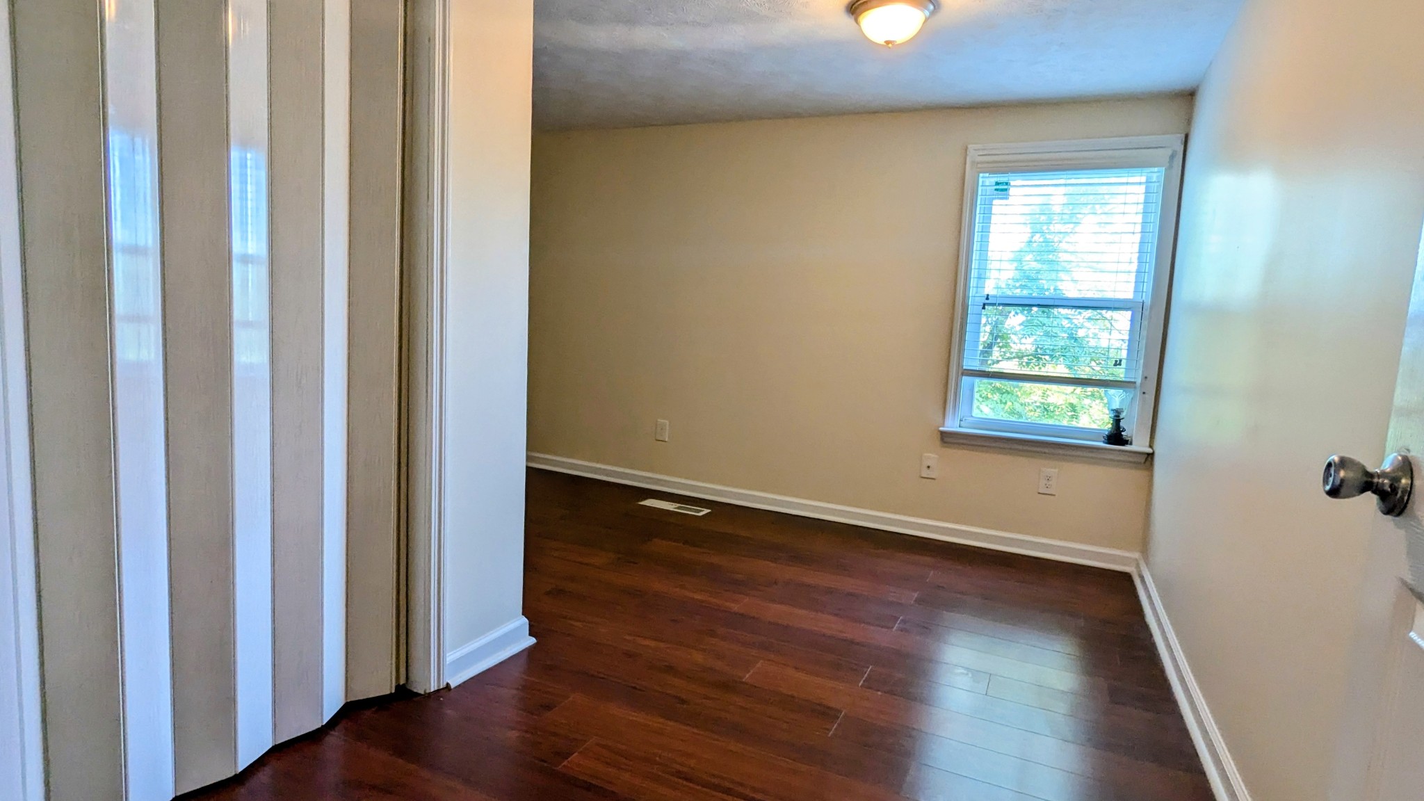 335 Turkey Creek Road Carthage, TN 37030 - Photo 20 of 36 a view of an empty room with wooden floor and a window
