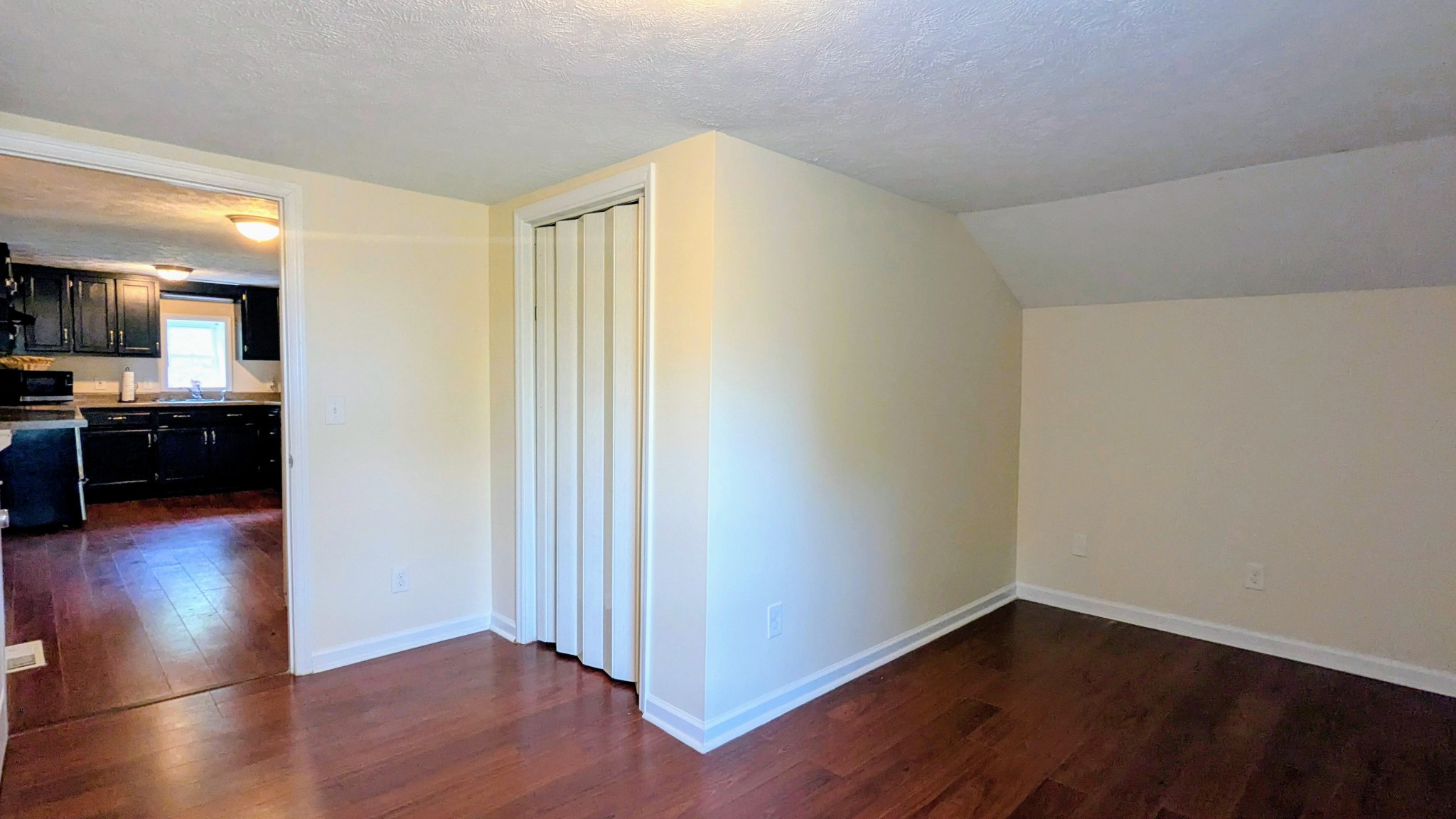 335 Turkey Creek Road Carthage, TN 37030 - Photo 22 of 36 a view of a livingroom with wooden floor and a kitchen