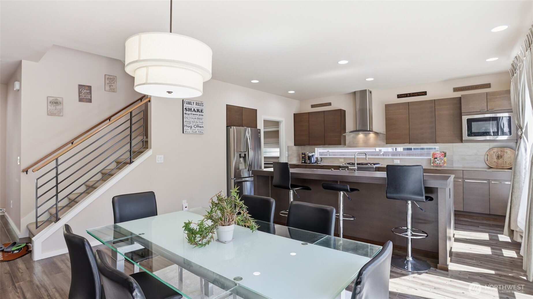 3709 Northeast 24th Street Renton, WA 98056 - Photo 11 of 37 a kitchen with stainless steel appliances a table chairs and a refrigerator