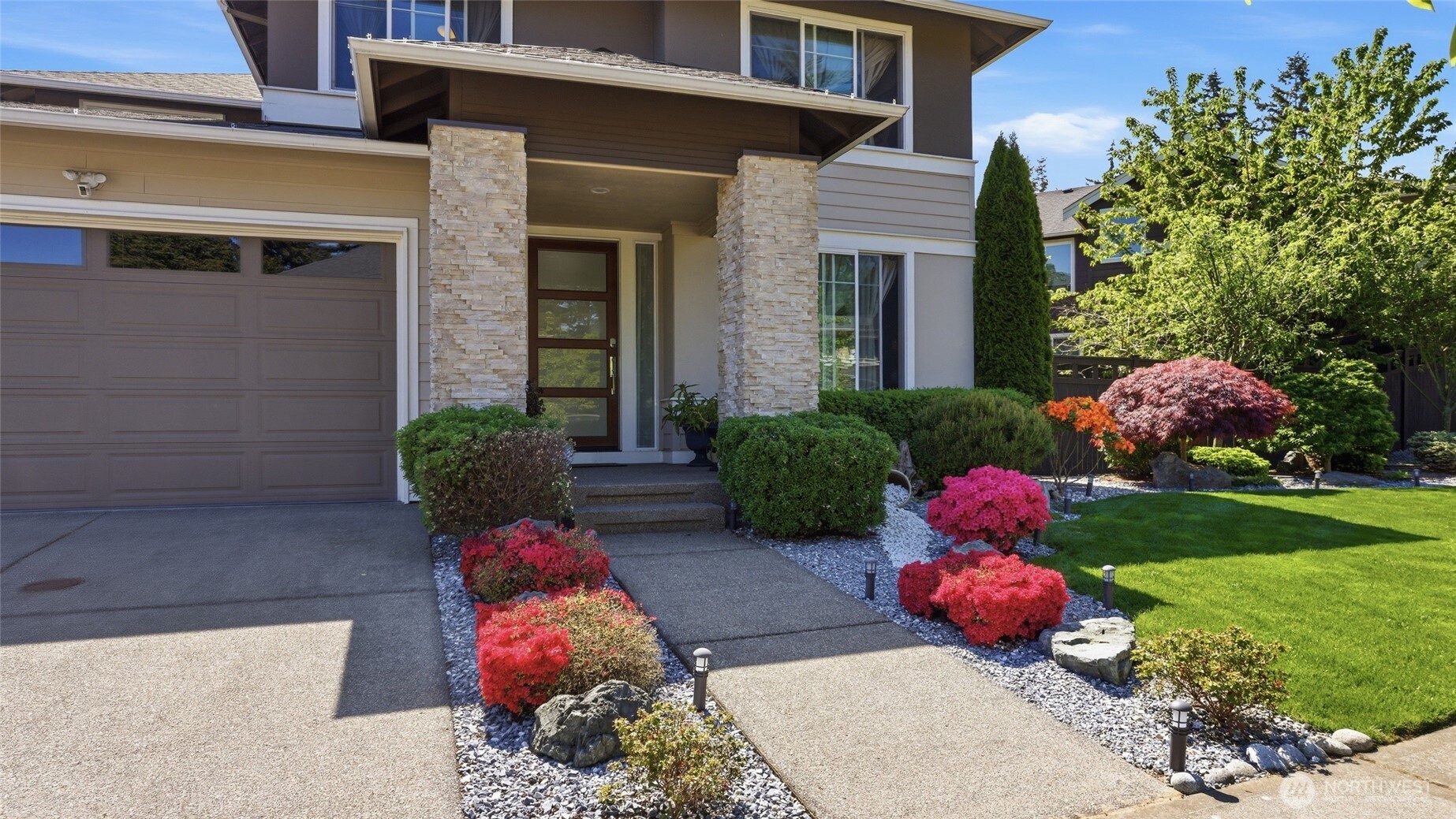 3709 Northeast 24th Street Renton, WA 98056 - Photo 3 of 37 a bunch of flowers sitting in front of a house