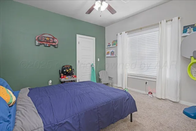 a bed sitting in a bedroom next to a window