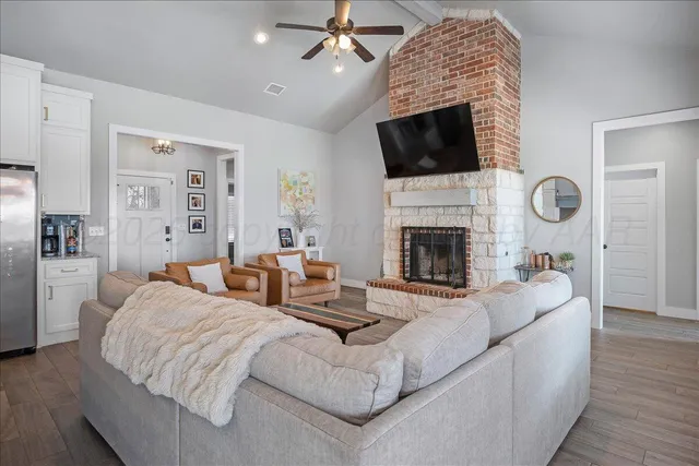 a living room with fireplace furniture and a flat screen tv