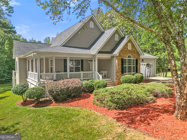 a front view of a house with a yard and porch
