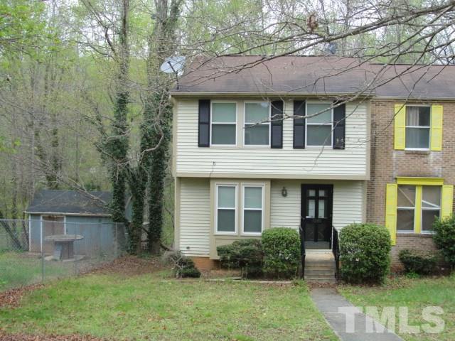 7286 Shellburne Drive, Unit J1 Raleigh, NC 27612 - Photo 1 of 11 a view of a brick house with a yard and plants