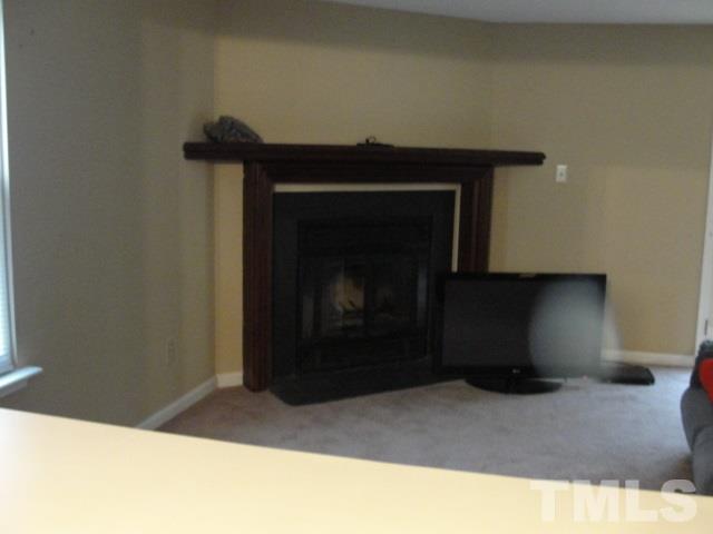 7286 Shellburne Drive, Unit J1 Raleigh, NC 27612 - Photo 3 of 11 a living room with a fireplace