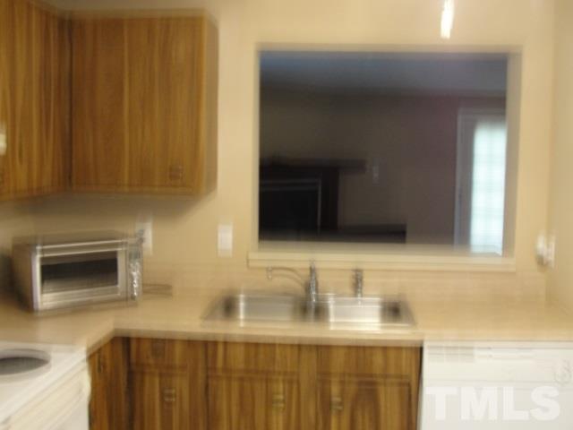 7286 Shellburne Drive, Unit J1 Raleigh, NC 27612 - Photo 8 of 11 a bathroom with a sink and a mirror