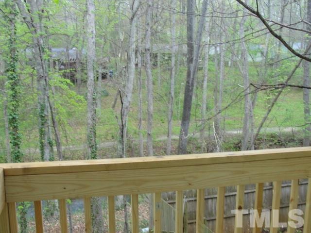 7286 Shellburne Drive, Unit J1 Raleigh, NC 27612 - Photo 9 of 11 a view of a yard and trees