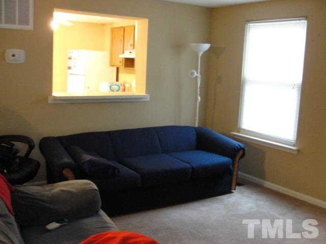 7286 Shellburne Drive, Unit J1 Raleigh, NC 27612 - Photo 10 of 11 a living room with furniture and a window