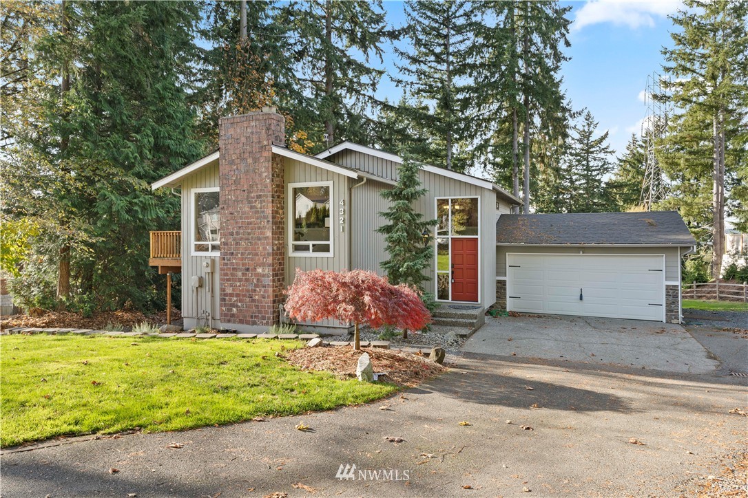 4321 234th Place Southeast Bothell, WA 98021 - Photo 1 of 25 a front view of house with yard and trees in the background