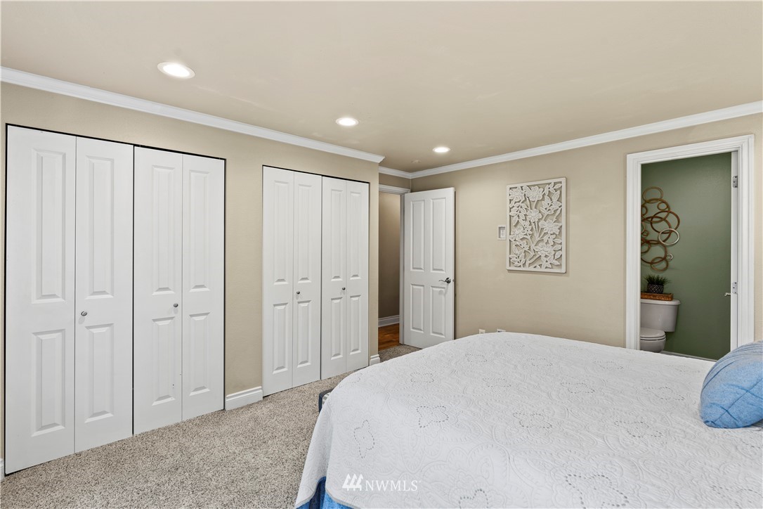 4321 234th Place Southeast Bothell, WA 98021 - Photo 11 of 25 a bedroom with a large bed a walk in closet and closet