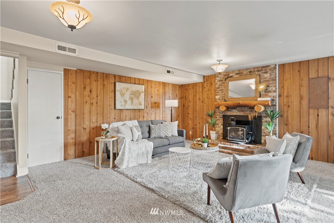 4321 234th Place Southeast Bothell, WA 98021 - Photo 15 of 25 a living room with furniture and a fireplace