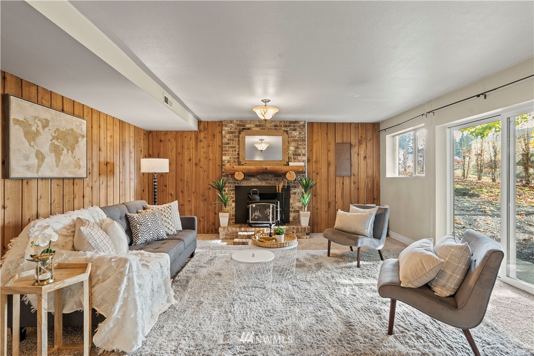 4321 234th Place Southeast Bothell, WA 98021 - Photo 16 of 25 a living room with furniture fireplace and a large window