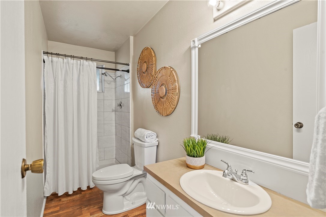 4321 234th Place Southeast Bothell, WA 98021 - Photo 17 of 25 a bathroom with a toilet a sink and a mirror