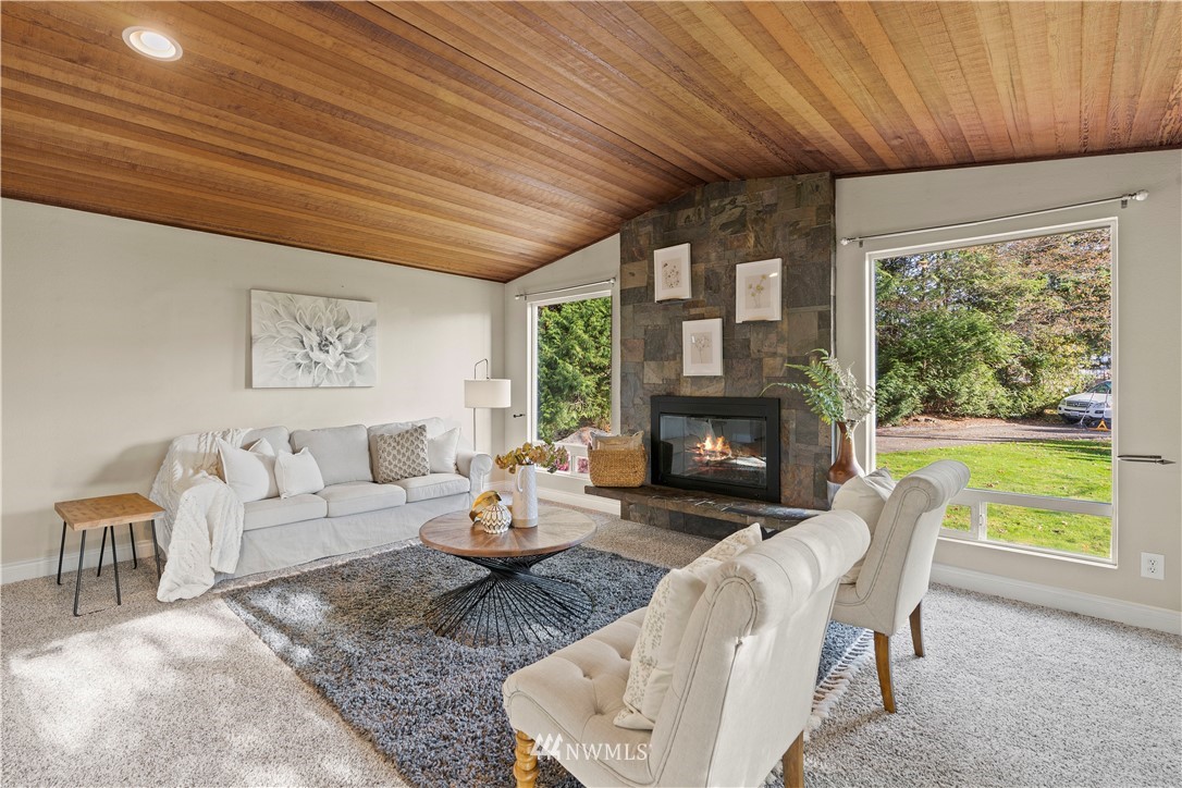 4321 234th Place Southeast Bothell, WA 98021 - Photo 4 of 25 a living room with furniture a fireplace and a large window