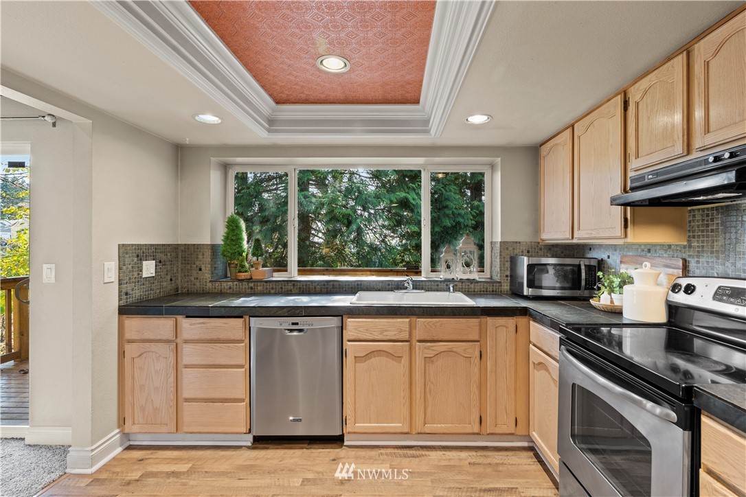 4321 234th Place Southeast Bothell, WA 98021 - Photo 6 of 25 a kitchen with a sink stove top oven and cabinets