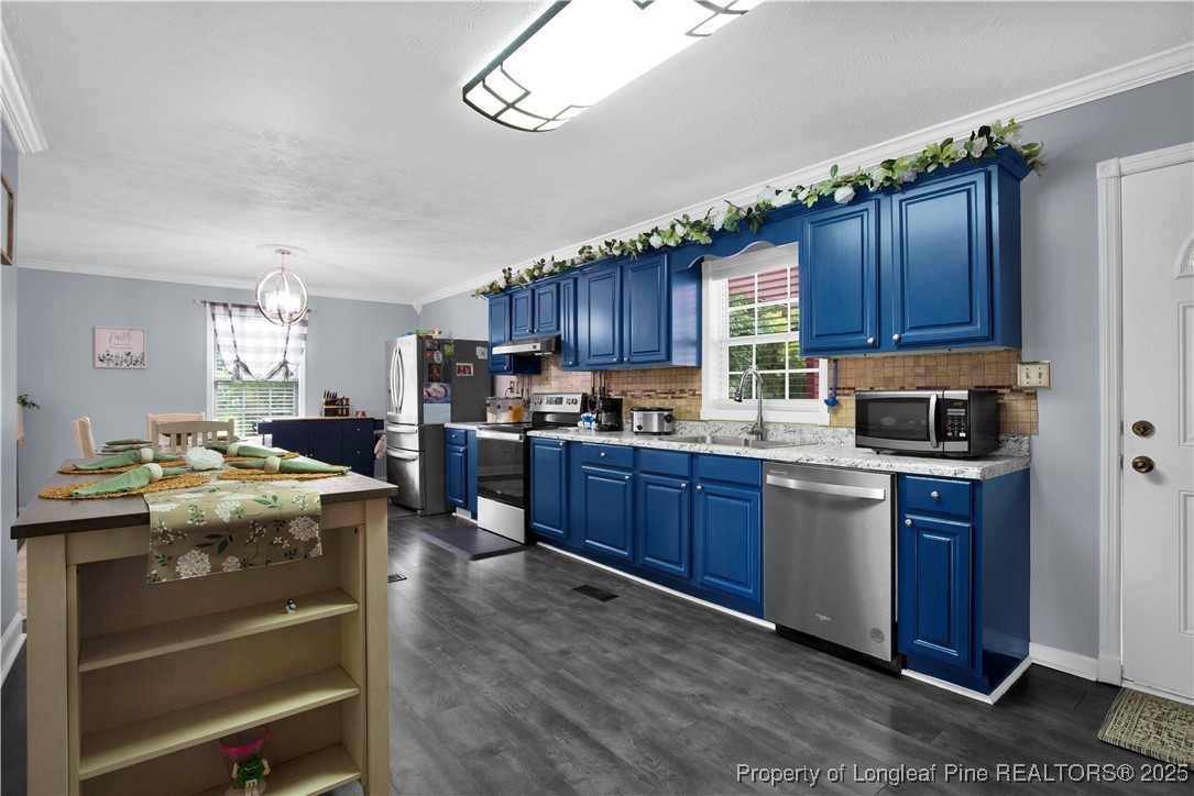 152 Singletary Road Lumberton, NC 28358 - Photo 11 of 33 a kitchen with granite countertop wooden cabinets and stainless steel appliances