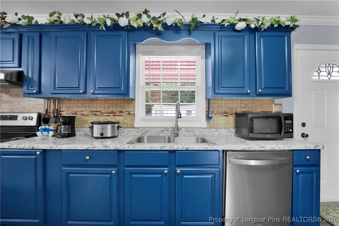 152 Singletary Road Lumberton, NC 28358 - Photo 13 of 33 a kitchen with granite countertop wooden cabinets a sink and dishwasher