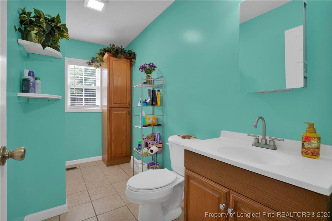 152 Singletary Road Lumberton, NC 28358 - Photo 17 of 33 a bathroom with a sink toilet and a mirror