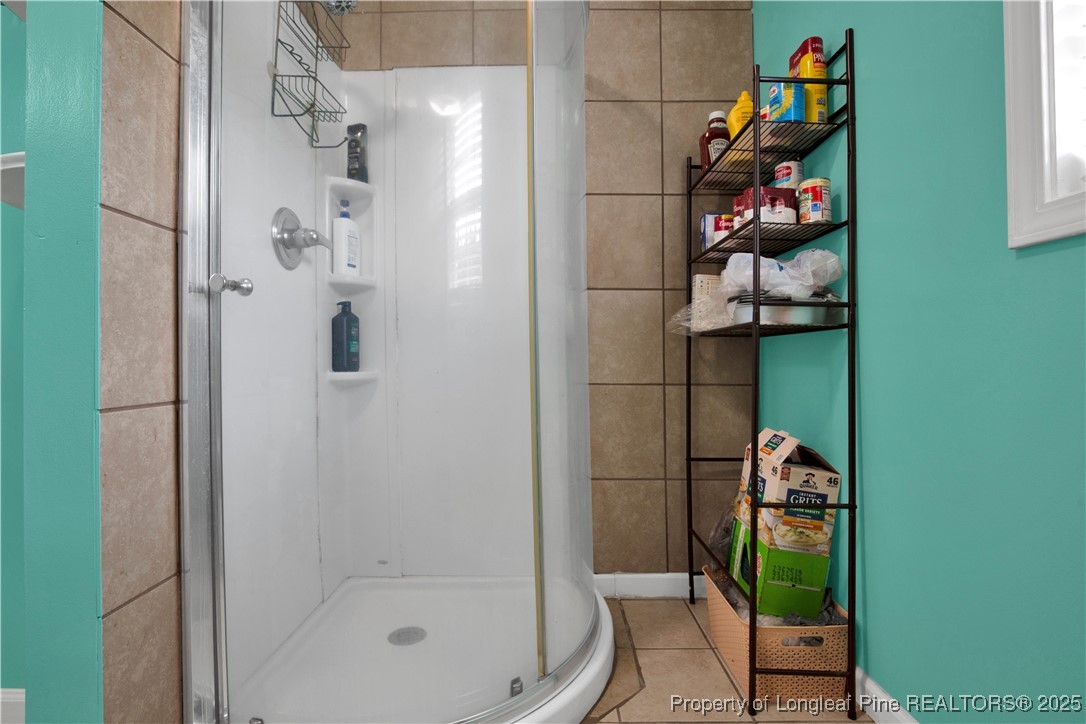 152 Singletary Road Lumberton, NC 28358 - Photo 18 of 33 a bathroom with a shower and a sink