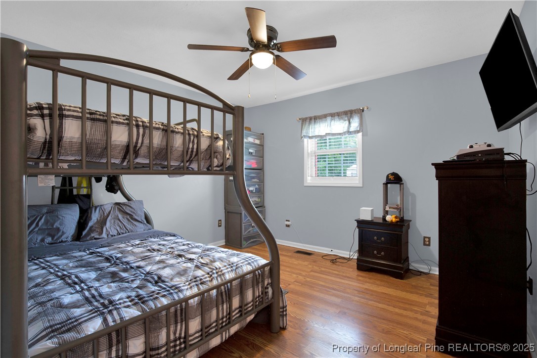 152 Singletary Road Lumberton, NC 28358 - Photo 19 of 33 a bedroom with a bed and a flat tv screen on the dresser
