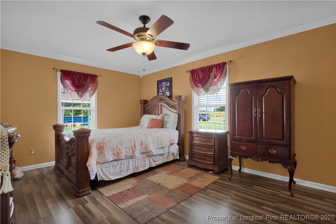 152 Singletary Road Lumberton, NC 28358 - Photo 21 of 33 a bedroom with a bed and wooden floor
