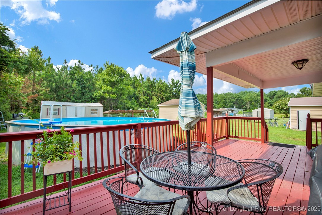 152 Singletary Road Lumberton, NC 28358 - Photo 25 of 33 a view of a patio with a table chairs and a garden