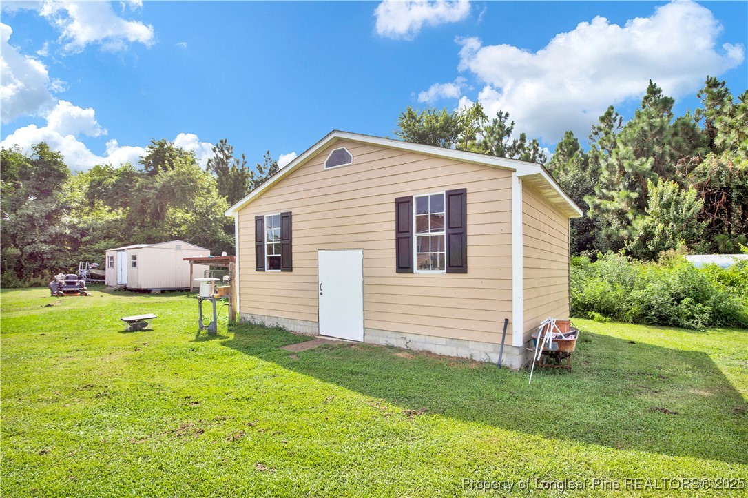 152 Singletary Road Lumberton, NC 28358 - Photo 31 of 33 a view of a house with a backyard