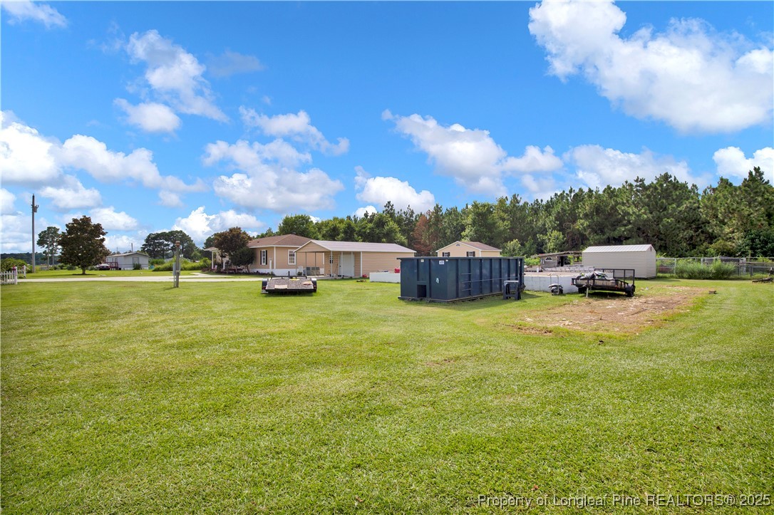 152 Singletary Road Lumberton, NC 28358 - Photo 4 of 33 a front view of a house with a garden and yard