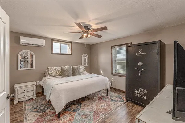 a bedroom with a large bed and a chandelier